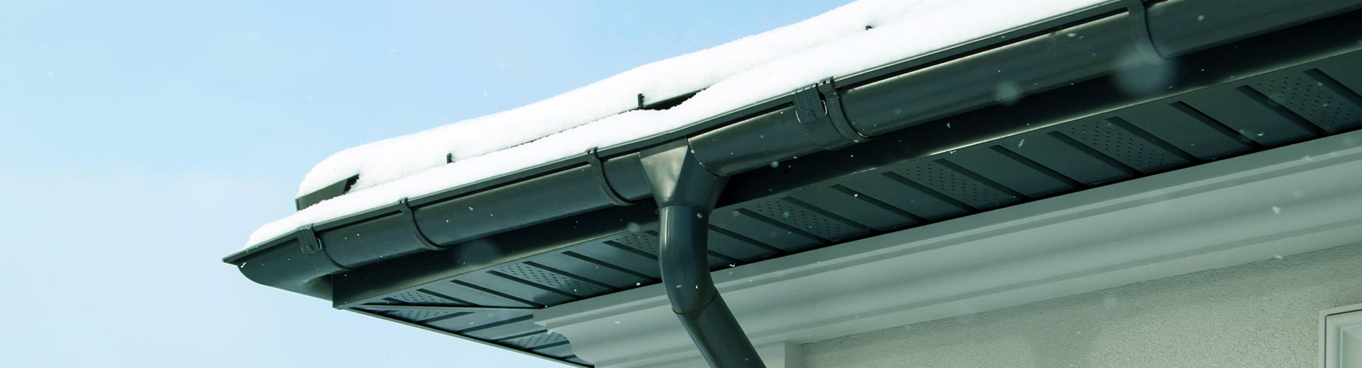 close up of a gutter covered on snow waynesville nc